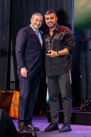 Rabbi Dr. Ari Berman, President of Yeshiva University, honors Israeli singer-songwriter Ishay Ribo with the Or l’Yisrael (Light of Israel) award for his support of soldiers and other Israeli communities in need of comfort and inspiration.